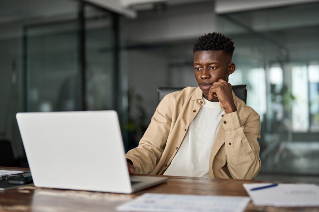 Busy African Black business man employee or student using laptop computer.